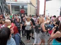 Crowds drinking beer next to Corn Barge statue